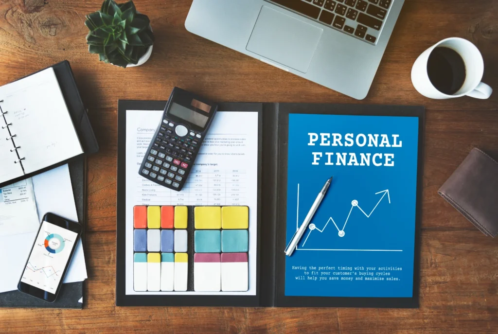 A person organizing their finances with a calculator, notebook, and budget plan, symbolizing breaking poor financial habits.