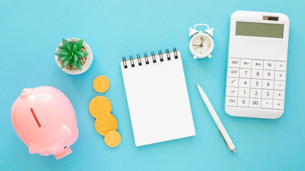 A person reviewing a financial plan on a tablet, surrounded by a notebook, coffee cup, and investment charts, symbolizing the Top Financial Habits to Adopt for Wealth in 2025.