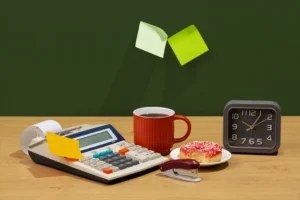 A person organizing financial documents on a desk, surrounded by a laptop, calculator, and budget planner, symbolizing the Top Financial Habits to master in 2025.